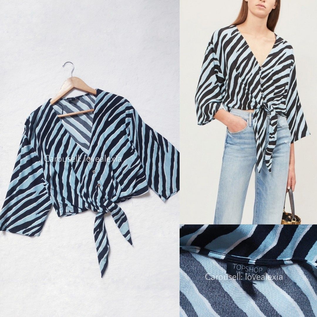 TOPSHOP Zebra Print Tie Front Blouse (Category: Blouses) located in Marikina City. Submitted by lovealexia (Listing ID 1434364558, Image 1). Description: — New and washed — Large on tag (Fits M-XL) With minor flaw: Color transfer at the back, as seen in 2nd photo. Zara H&M Bershka.