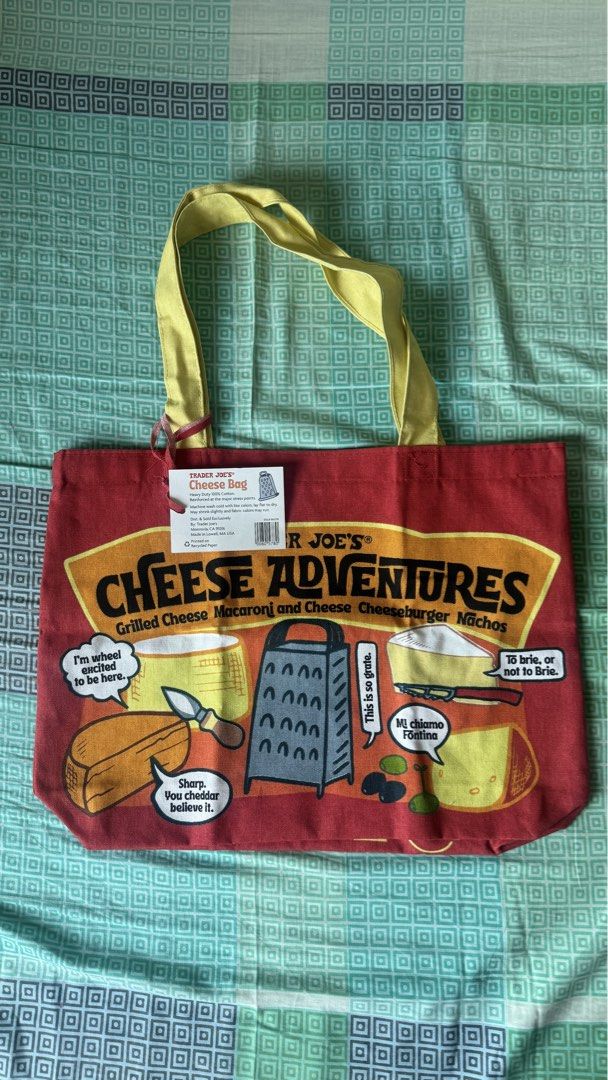 Trader Joe's Cheese Experience Tote Bag (Category: Tote Bags) located in Binan City. Submitted by nice_box (Listing ID 1434197387, Image 3). Description: - Trader Joe's "Cheese Experience" tote bag - Made of heavy-duty 100% cotton - Reinforced at stress points - Machine washable - Dimensions: Approximately 14 inches (H) x 19 inches (W) - Features yellow handles and a red body with cheese-themed graphics.