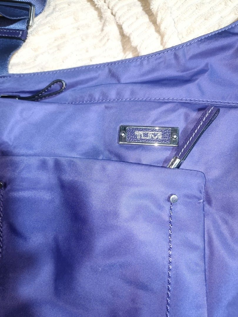 Tumi Carson voyageur Shoulder Bag (Category: Luxury Bags & Wallets) located in Manila. Submitted by coolfish_6a61f5 (Listing ID 1434331784, Image 2). Description: - Authentic Tumi shoulder bag - Eye-catching purple color - Adjustable strap for comfortable wear - Multiple compartments for organization - Main zippered section for security - Exterior pockets for easy access - Stylish light pink interior lining - Includes genuine Tumi leather tag - F
