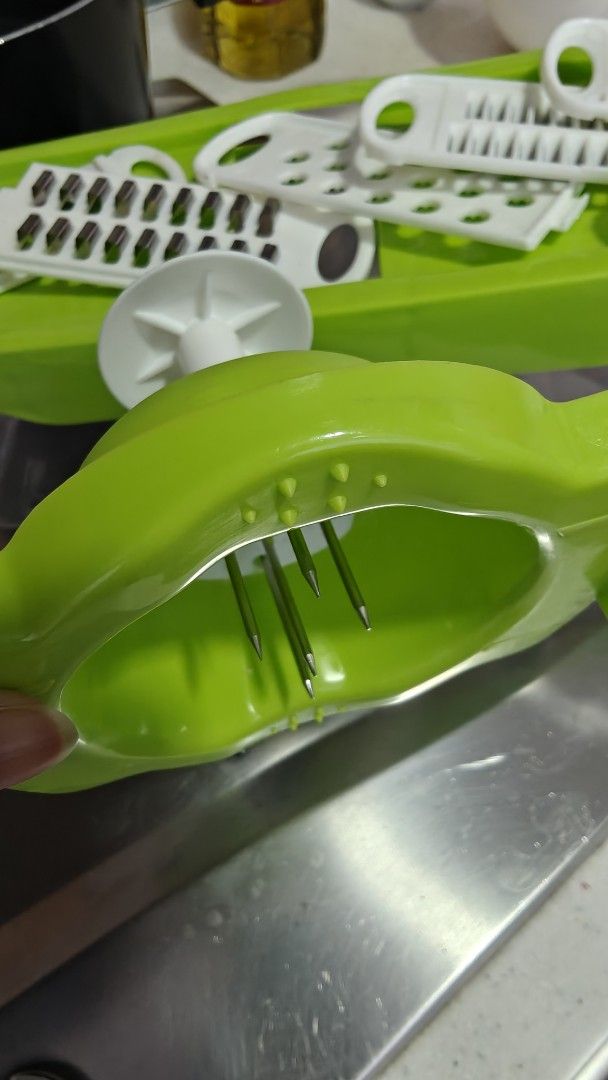 Vegetable Slicer with Multiple Blades (Category: Knives & Chopping Boards) located in Singapore. Submitted by hellokiara (Listing ID 1434384272, Image 2). Description: - Vegetable slicer with interchangeable blades. - Includes a green base and white blade attachments. - Perfect for various slicing and grating tasks..