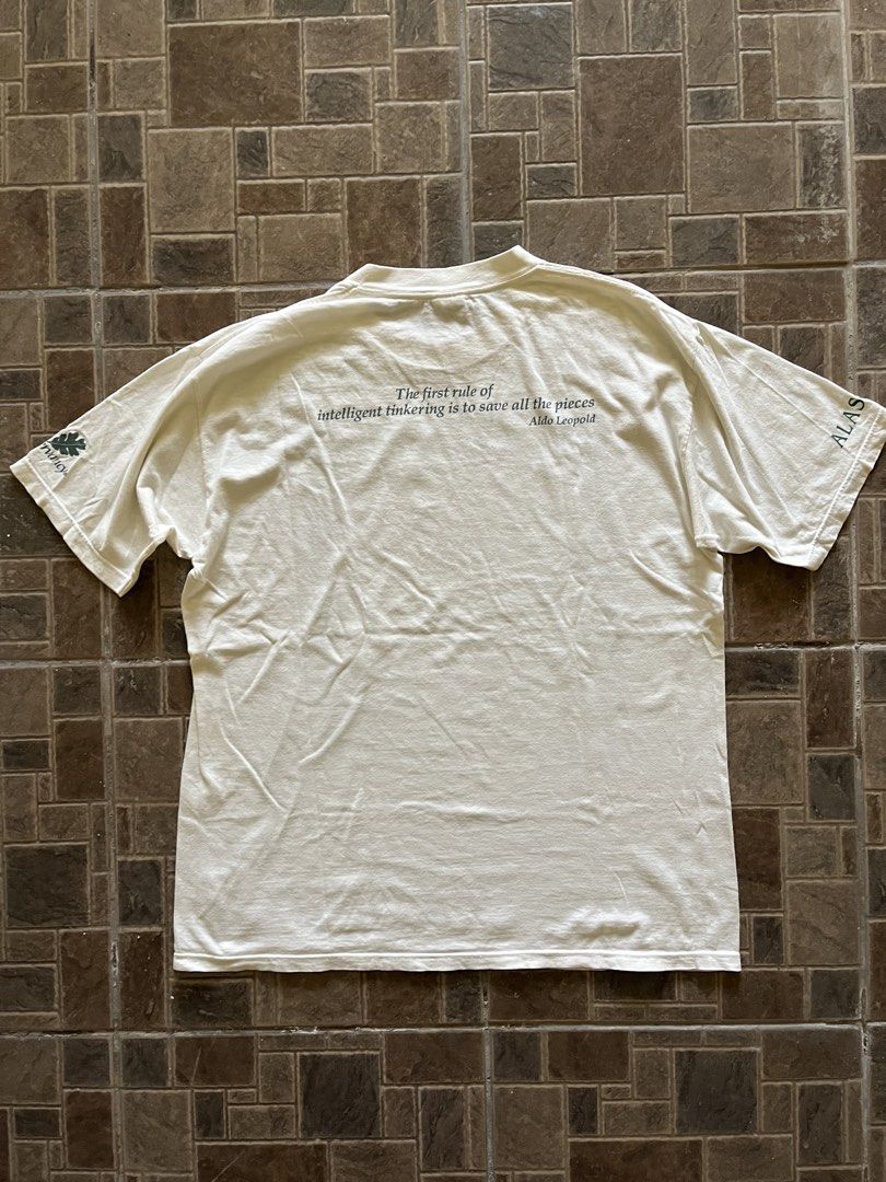 Vintage 1990s The Nature Conservancy Wolf Graphic Tee (Category: Tshirts & Polo Shirts ) located in San Narciso. Submitted by shanthriftdope (Listing ID 1434309032, Image 2). Description: -90s Down To Earth tag -XL (23x30) - Vintage The Nature Conservancy t-shirt - Features a wolf graphic on the front - Aldo Leopold quote on the back - Color: White - Graphics and text color: Green - Style: Short sleeves, crew neck.