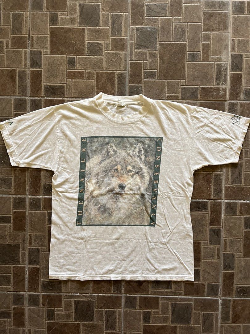 Vintage 1990s The Nature Conservancy Wolf Graphic Tee (Category: Tshirts & Polo Shirts ) located in San Narciso. Submitted by shanthriftdope (Listing ID 1434309032, Image 1). Description: -90s Down To Earth tag -XL (23x30) - Vintage The Nature Conservancy t-shirt - Features a wolf graphic on the front - Aldo Leopold quote on the back - Color: White - Graphics and text color: Green - Style: Short sleeves, crew neck.