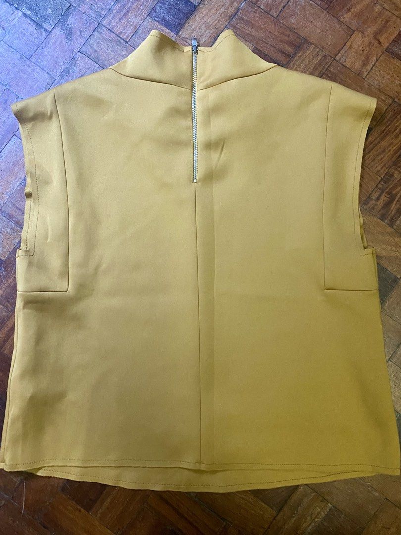 Zara Mustard Top (Category: Blouses) located in Makati City. Submitted by sweetsj (Listing ID 1434252380, Image 2). Description: - Zara mustard top - High neckline - Zipper closure at the back - Sleeveless - Boxy silhouette - Size M .