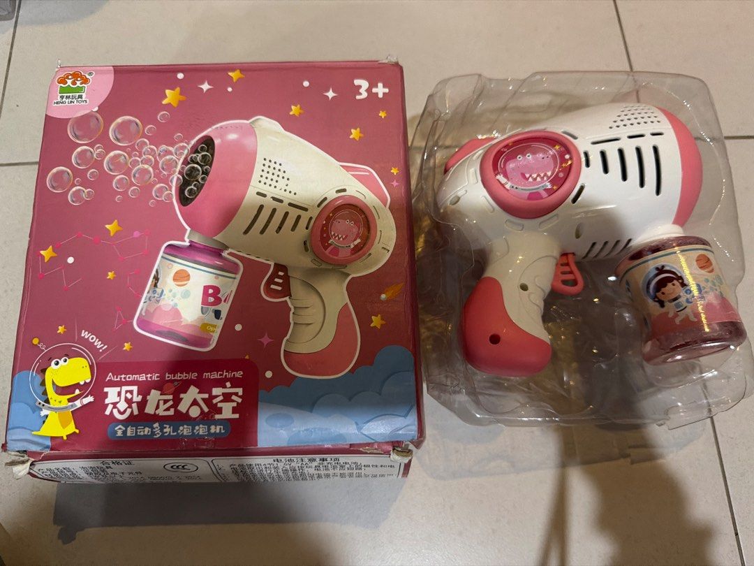 Automatic Bubble Machine - Pink (Category: Kids Toys) located in Singapore. Submitted by clearance.in.progress (Listing ID 1434508286, Image 1). Description: - automatic bubble machine - Includes a bottle of bubble solution - Recommended for children aged 3+ - Ideal for outdoor fun and parties - Item is in perfect condition - Box has minor damage.