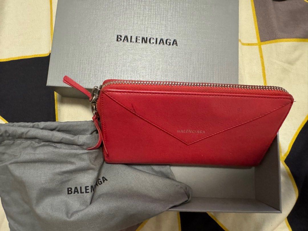 Balenciaga Red Zip Around Wallet (Category: Luxury Bags & Wallets) located in Caloocan City. Submitted by r_h_e_a10 (Listing ID 1430272324, Image 1). Description: Authentic Balenciaga red zip around wallet. Includes original box and dust bag. Features a zip closure, and the Balenciaga logo is visible on the front. The zipper is silver-toned..