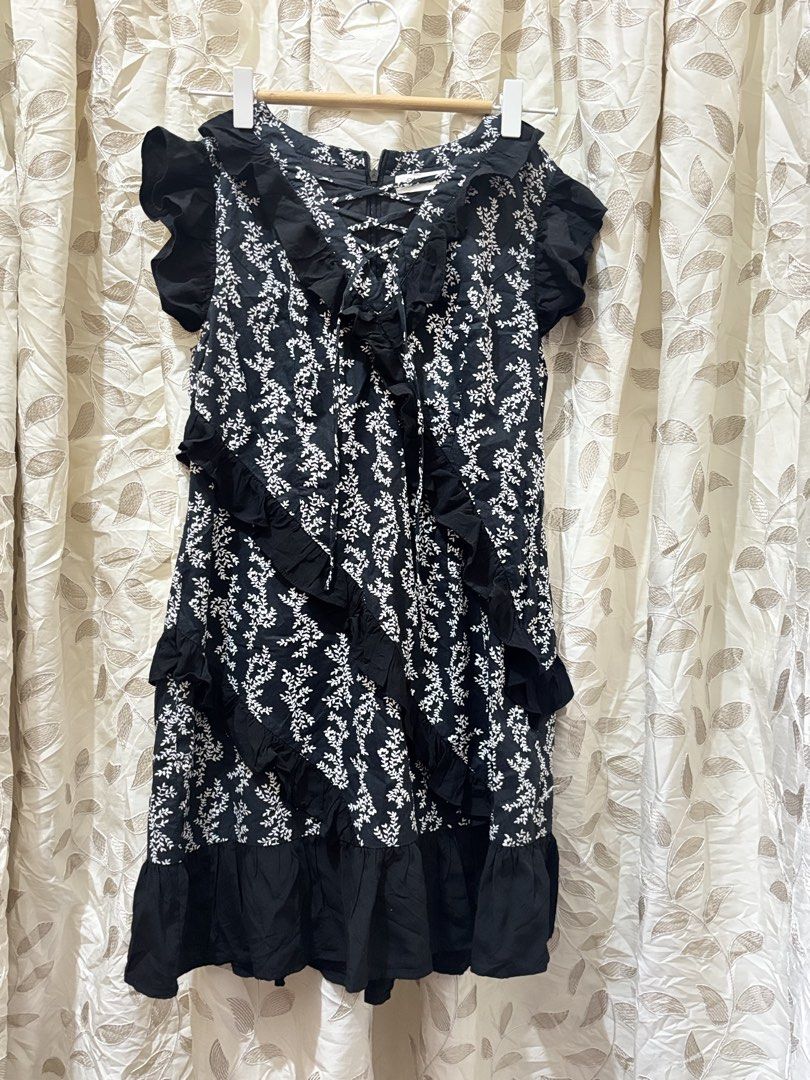 Black Floral Ruffle Dress (Category: Dresses) located in Baguio. Submitted by ravendoll.ph (Listing ID 1434475246, Image 1). Description: - Black dress with a delicate white floral pattern. - Ruffle detailing on the front and sleeves. - Tiered skirt. - Lace-up detail at the neckline. - Zipper closure at the back. - Sleeveless design. - Round neckline..