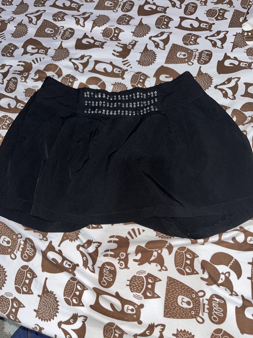 Black Skirt with Embellishments (Category: Skirts) located in Jaen. Submitted by smthrys (Listing ID 1434480459, Image 1). Description: - Black flared skirt - Decorative embellishments on waistband - Made of smooth, silky fabric - Solid black color.