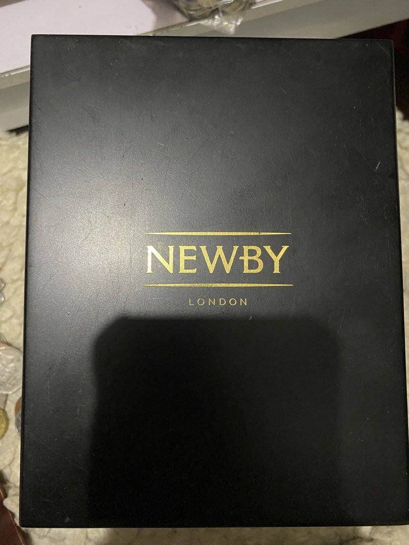 Boreas Silver-Plated Luxury Tea Caddy from Newby Teas. (Category: Coffee & Tea Tableware) located in Manila. Submitted by kulabostor44357 (Listing ID 1434395612, Image 1). Description: - Newby London tea caddy - Black exterior with gold lettering - Silver-toned interior - Decorative silver lid with purple backing - Silver emblem on the bottom - Ideal for tea enthusiasts and collectors.