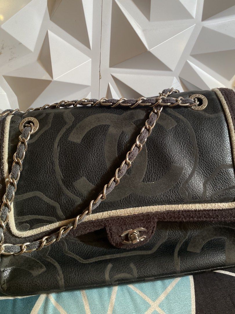 Chanel Camellia Medium Flap Bag (Category: Luxury Bags & Wallets) located in Manila. Submitted by miss__sty (Listing ID 1434475715, Image 1). Description: Black Chanel shoulder bag with floral pattern. Features a chain strap with a fabric detail. The interior is red with the Chanel logo. Includes a magnetic closure..