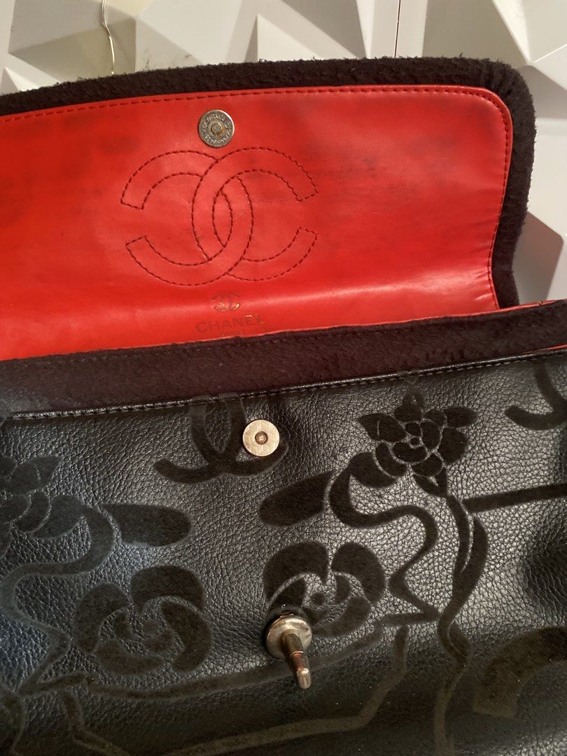 Chanel Camellia Medium Flap Bag (Category: Luxury Bags & Wallets) located in Manila. Submitted by miss__sty (Listing ID 1434475715, Image 2). Description: Black Chanel shoulder bag with floral pattern. Features a chain strap with a fabric detail. The interior is red with the Chanel logo. Includes a magnetic closure..