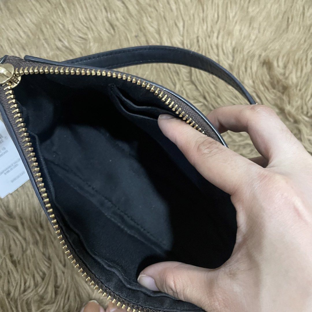 Coach Nolita (Category: Luxury Bags & Wallets) located in Taguig. Submitted by adaapot (Listing ID 1434481894, Image 3). Description: - Authentic Coach Original Price 7,000 Negotiable - Signature brown print - Top zipper closure - Wrist strap - Small interior pocket - Includes original tags - Black interior - Gold-toned hardware - Made in Bangladesh.