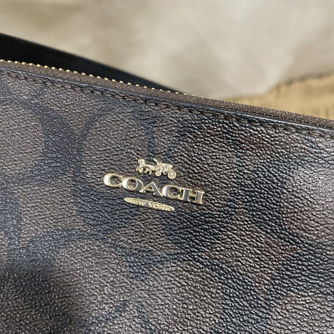 Coach Nolita (Category: Luxury Bags & Wallets) located in Taguig. Submitted by adaapot (Listing ID 1434481894, Image 2). Description: - Authentic Coach Original Price 7,000 Negotiable - Signature brown print - Top zipper closure - Wrist strap - Small interior pocket - Includes original tags - Black interior - Gold-toned hardware - Made in Bangladesh.