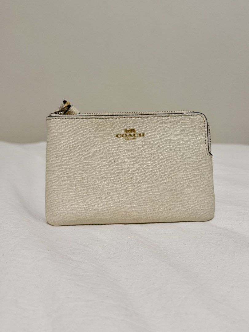 Coach Wristlet (Category: Luxury Bags & Wallets) located in Taguig. Submitted by 77dbae (Listing ID 1434545502, Image 1). Description: Cream Coach wristlet - Zip closure - Wrist strap - Interior card slots rfs: decluttering.