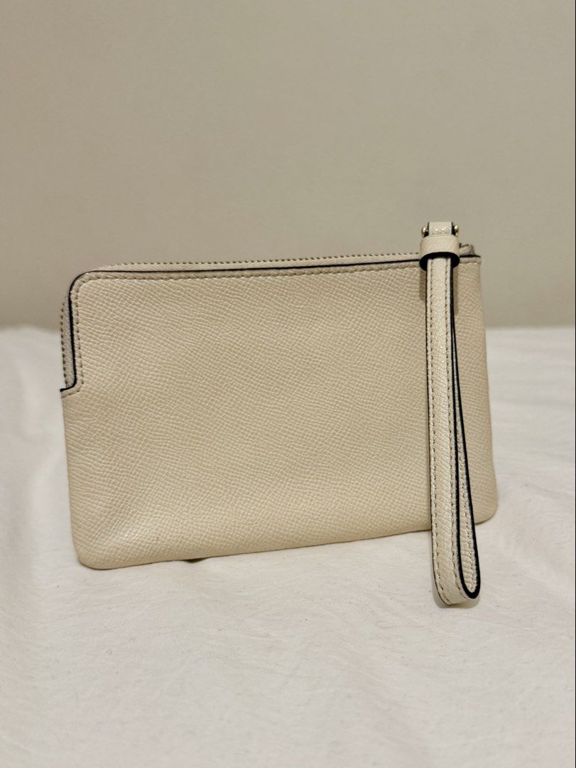 Coach Wristlet (Category: Luxury Bags & Wallets) located in Taguig. Submitted by 77dbae (Listing ID 1434545502, Image 2). Description: Cream Coach wristlet - Zip closure - Wrist strap - Interior card slots rfs: decluttering.
