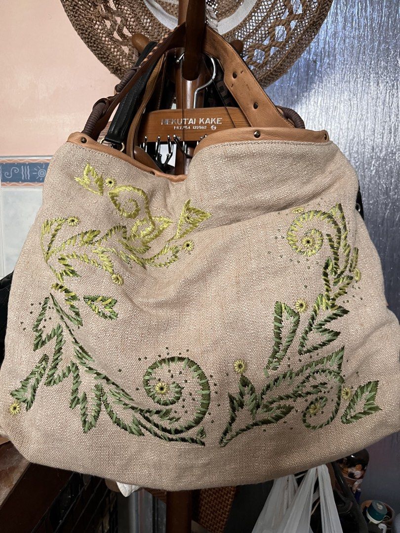 Cole Haan Embroidered Handbag (Category: Luxury Bags & Wallets) located in Los Banos. Submitted by profemy (Listing ID 1434452732, Image 1). Description: - Cole Haan handbag - Embroidered floral design - Beige canvas body - Leather trim and handles - Interior zipper pocket - Two slip pockets - Top handle and shoulder strap - Light brown fabric lining - Cole Haan tag inside AUTHENTIC COLE HAAN Measures 46 cm at the widest point, 33 cm (hright), 15