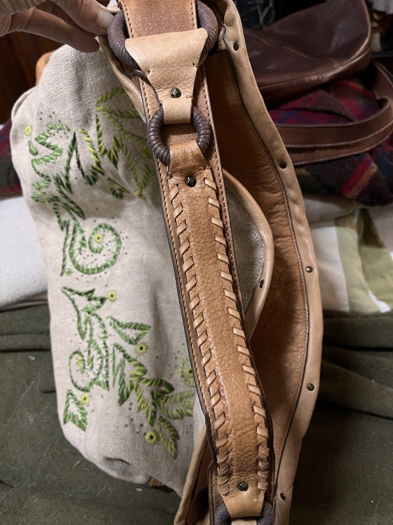 Cole Haan Embroidered Handbag (Category: Luxury Bags & Wallets) located in Los Banos. Submitted by profemy (Listing ID 1434452732, Image 3). Description: - Cole Haan handbag - Embroidered floral design - Beige canvas body - Leather trim and handles - Interior zipper pocket - Two slip pockets - Top handle and shoulder strap - Light brown fabric lining - Cole Haan tag inside AUTHENTIC COLE HAAN Measures 46 cm at the widest point, 33 cm (hright), 15