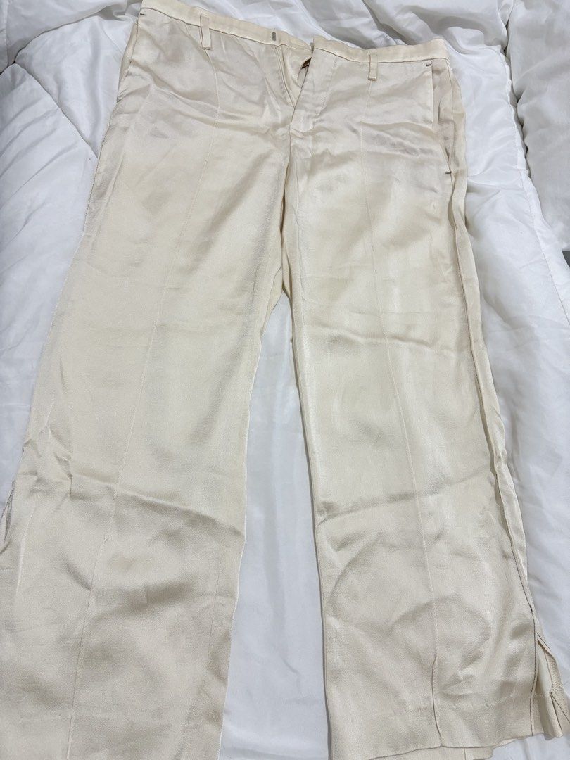 Cream-colored Wide Leg Pants (Category: Other Bottoms) located in Manila. Submitted by sbm07 (Listing ID 1434472599, Image 1). Description: - Cream-colored wide-leg pants - Button and zipper closure - Vertical seams on front and back - Slits at leg openings - Fabric has a subtle sheen.