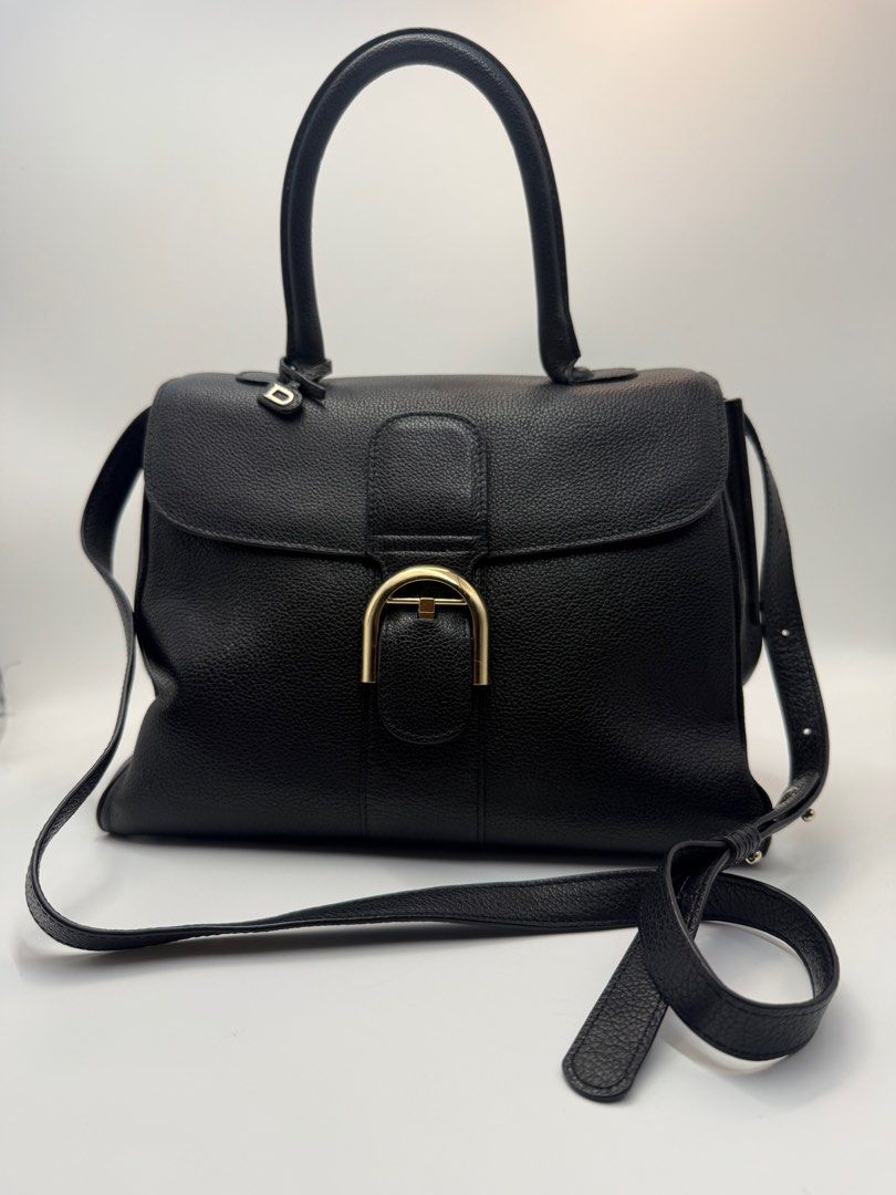 Delvaux Black Leather Handbag (Category: Luxury Bags & Wallets) located in Caloocan City. Submitted by rossvault2 (Listing ID 1434546797, Image 1). Description: - Delvaux black leather handbag - Top handle and detachable shoulder strap - Gold-tone buckle closure - Protective feet on the bottom - Interior zippered pocket - Textured leather finish - Includes 'D' charm -coded -ukay source, pls manage ur expectations -normal signs of use.