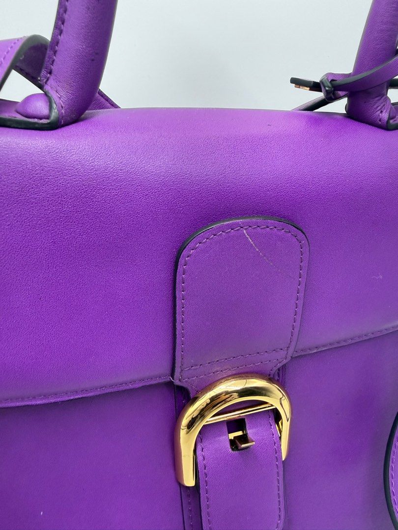 Delvaux Brillant bag (Category: Cross-body Bags) located in Caloocan City. Submitted by rossvault2 (Listing ID 1434543530, Image 3). Description: - Delvaux Brillant Mini handbag - Stunning purple color - Top handle and detachable shoulder strap - Gold-tone buckle closure and hardware - Interior zippered pocket - Made in France -coded white tag -ukay source pls manage ur expectations -normal signs of use.
