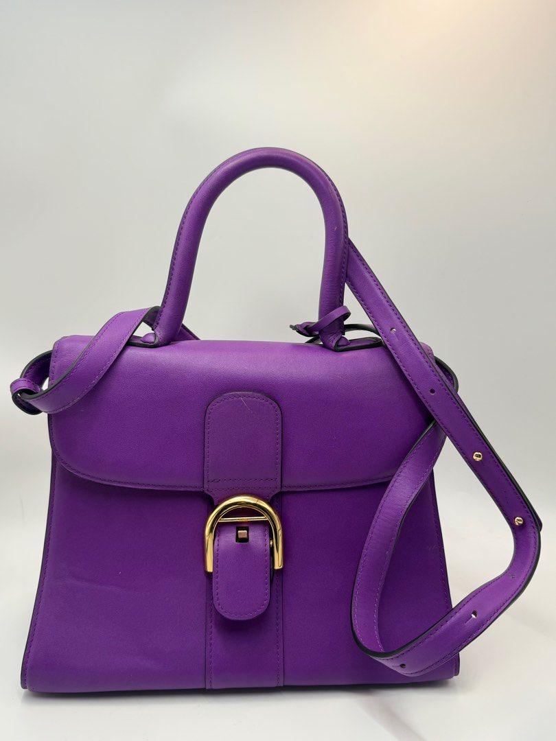 Delvaux Brillant bag (Category: Cross-body Bags) located in Caloocan City. Submitted by rossvault2 (Listing ID 1434543530, Image 2). Description: - Delvaux Brillant Mini handbag - Stunning purple color - Top handle and detachable shoulder strap - Gold-tone buckle closure and hardware - Interior zippered pocket - Made in France -coded white tag -ukay source pls manage ur expectations -normal signs of use.