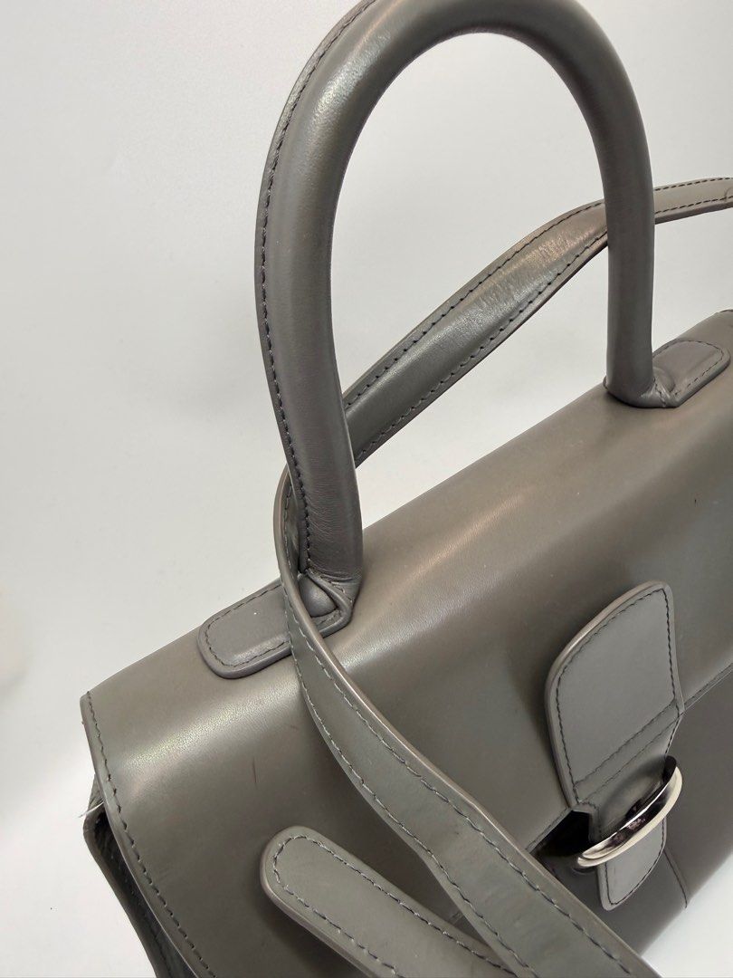 Delvaux Grey Leather bag (Category: Cross-body Bags) located in Caloocan City. Submitted by rossvault2 (Listing ID 1434533922, Image 2). Description: - Delvaux grey leather handbag - Top handle and detachable shoulder strap - Silver buckle closure - Interior with zippered pocket and compartments - Made in France - Minor wear on strap -coded/white tag -ukay source pls manage ur expectations -normal signs of use -sobrang kapal and structured .