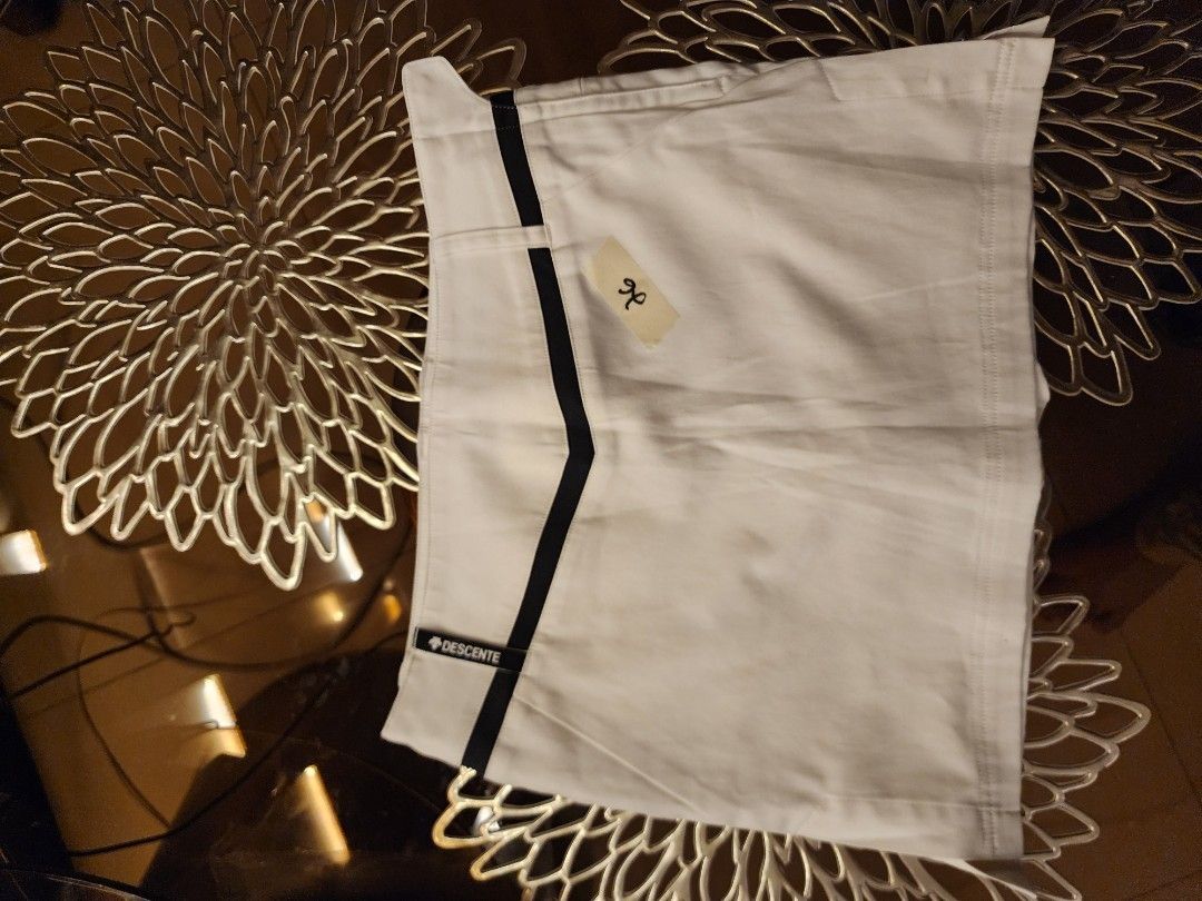 Descente White Shorts with Black Stripe (Category: Shorts) located in Caloocan City. Submitted by zheire (Listing ID 1434474160, Image 3). Description: - Descente white shorts - Black stripe detail - Size: 26 - Pockets included - Zipper closure - Made of sturdy material - Descente logo on waistband.