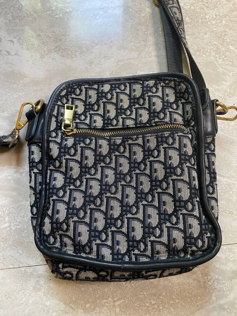 Dior Vibes Messenger Bag (Category: Luxury Bags & Wallets) located in Talacogon. Submitted by mr1070 (Listing ID 1434586206, Image 2). Description: - Dior Vibes messenger bag - Iconic Dior Oblique canvas - Zip closure - Gold-tone CD clasp - Main compartment - Small pocket - Shoulder strap - Color rating: 9.5/10 - No issues.