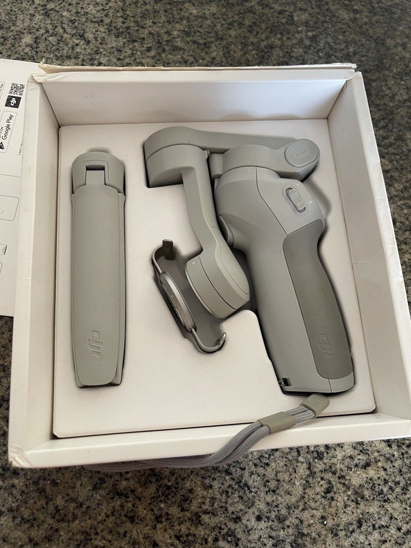 DJI OM 4 Smartphone Stabilizer (Category: Gimbals & Stabilizers ) located in Taguig. Submitted by supplementary (Listing ID 1434431525, Image 2). Description: DJI OM 4 smartphone stabilizer. Includes the stabilizer itself, a grip, and a wrist strap. The box is included. The stabilizer is designed to stabilize your smartphone for smooth video recording. It is a great tool for capturing high-quality videos and photos on the go..