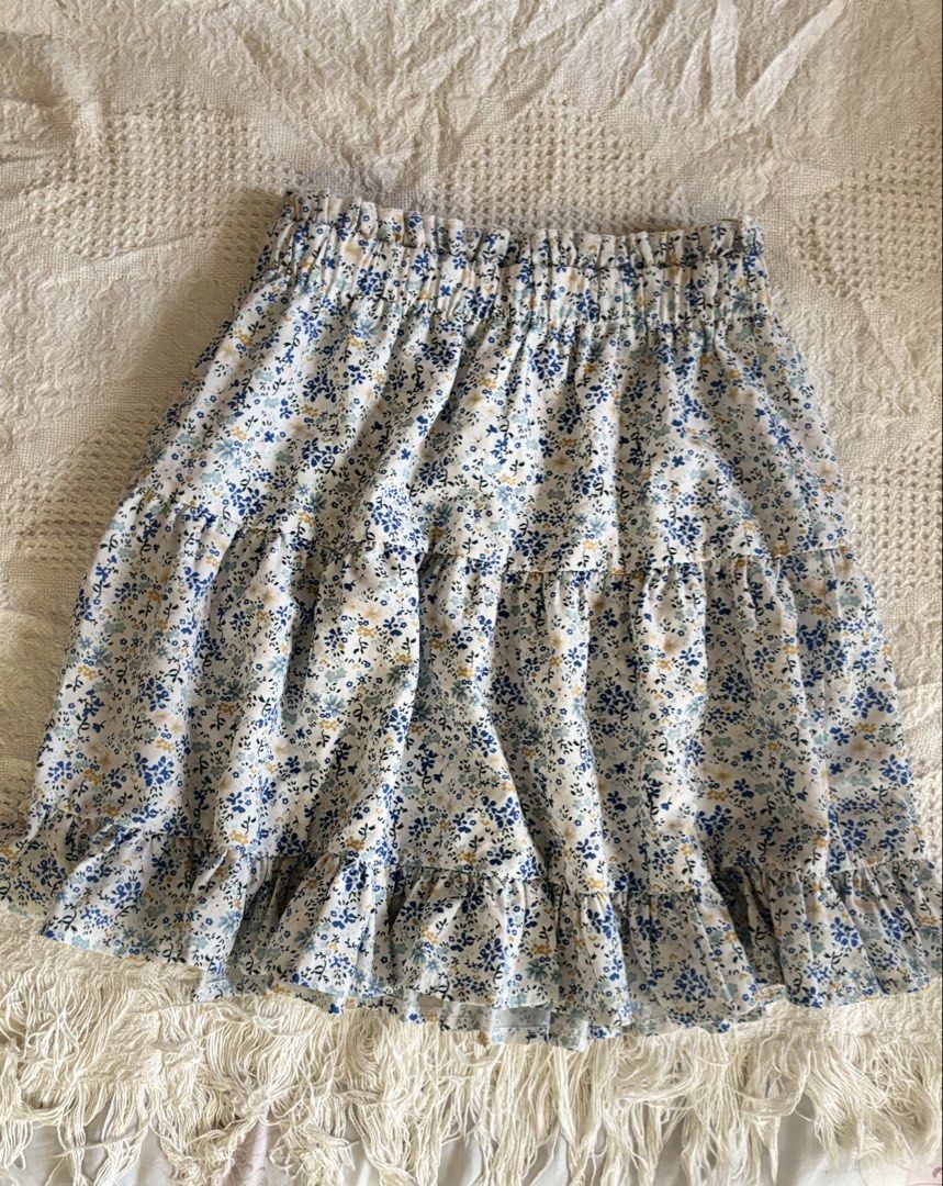 Floral Tiered Skirt (Category: Skirts) located in Baguio. Submitted by ravendoll.ph (Listing ID 1434471895, Image 1). Description: - Tiered mini skirt - Floral print: blue and yellow on white - Comfortable elastic waistband - Casual style.