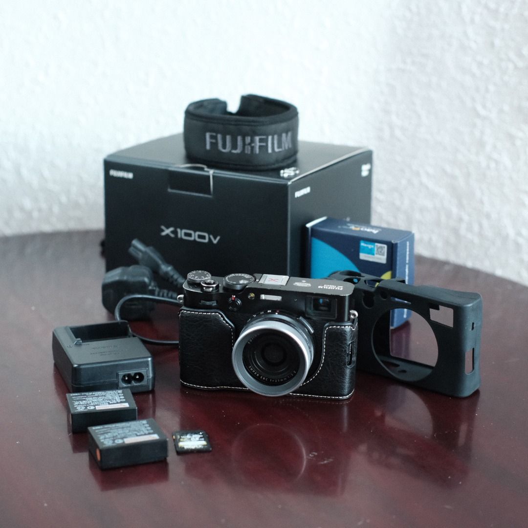 Fujifilm X100V (Category: Webcams) located in Makati City. Submitted by jmsobrevilla (Listing ID 1434499751, Image 1). Description: Fujifilm X100V (Black) Around 11,000 shutter count. No issues, works perfectly. Comes with: 2 batteries Memory card Leather half case Rubber full case Original Fujifilm charger Haoge front filter Hot shoe cover Camera strap Box The body has some paint fade from friction due to the rubber case, but no scratches or den