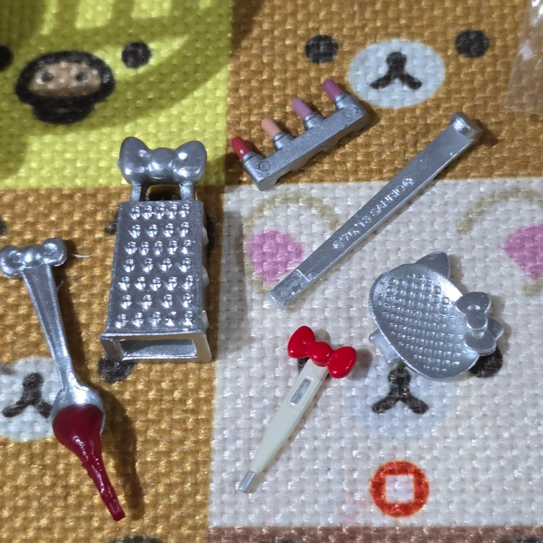 Hello Kitty Re-ment Loose Set (Category: Craft Supplies & Tools) located in Manila. Submitted by meshicollects (Listing ID 1434510823, Image 1). Description: - Miniature accessory set for toys. - Includes: - Kitty grater - Thermometer - Nail file - Syringe - Rectangular item with handle - Colors: Silver and red. - Perfect for dollhouses and miniature play..