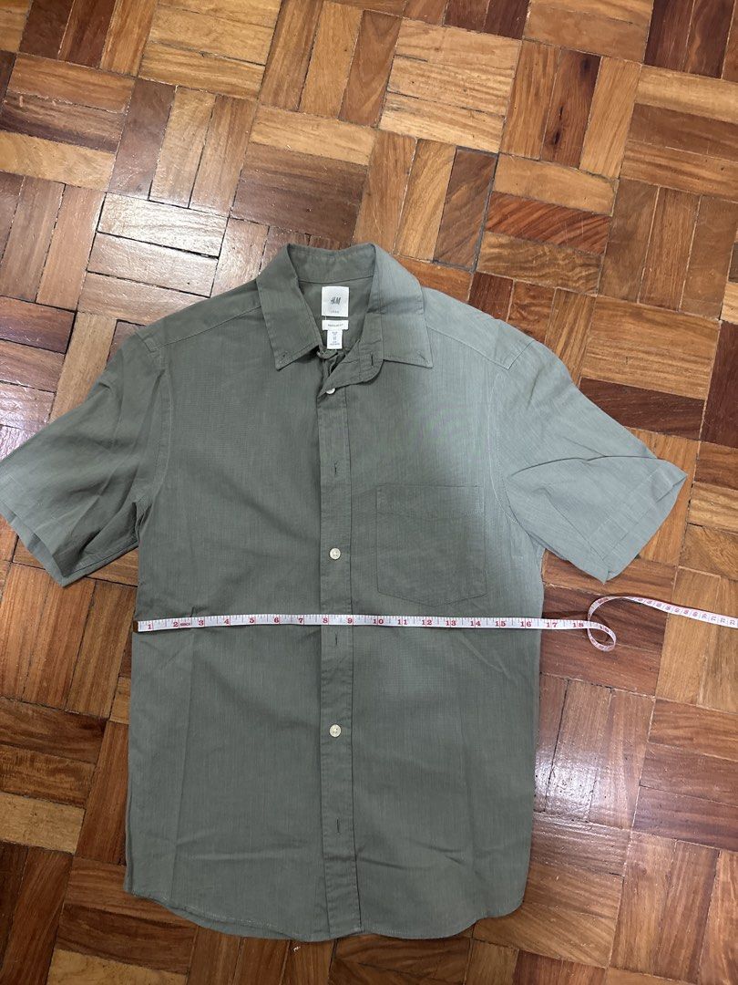 H&M Regular Fit Short Sleeve Shirt (Category: Tshirts & Polo Shirts ) located in Quezon City. Submitted by bagoffinds (Listing ID 1434475933, Image 3). Description: - H&M short sleeve shirt - Size: XS (EU) - Color: Solid Green - Fit: Regular - Features: Button-down front, chest pocket, classic collar - Material: Lightweight fabric - Ideal for warm weather.