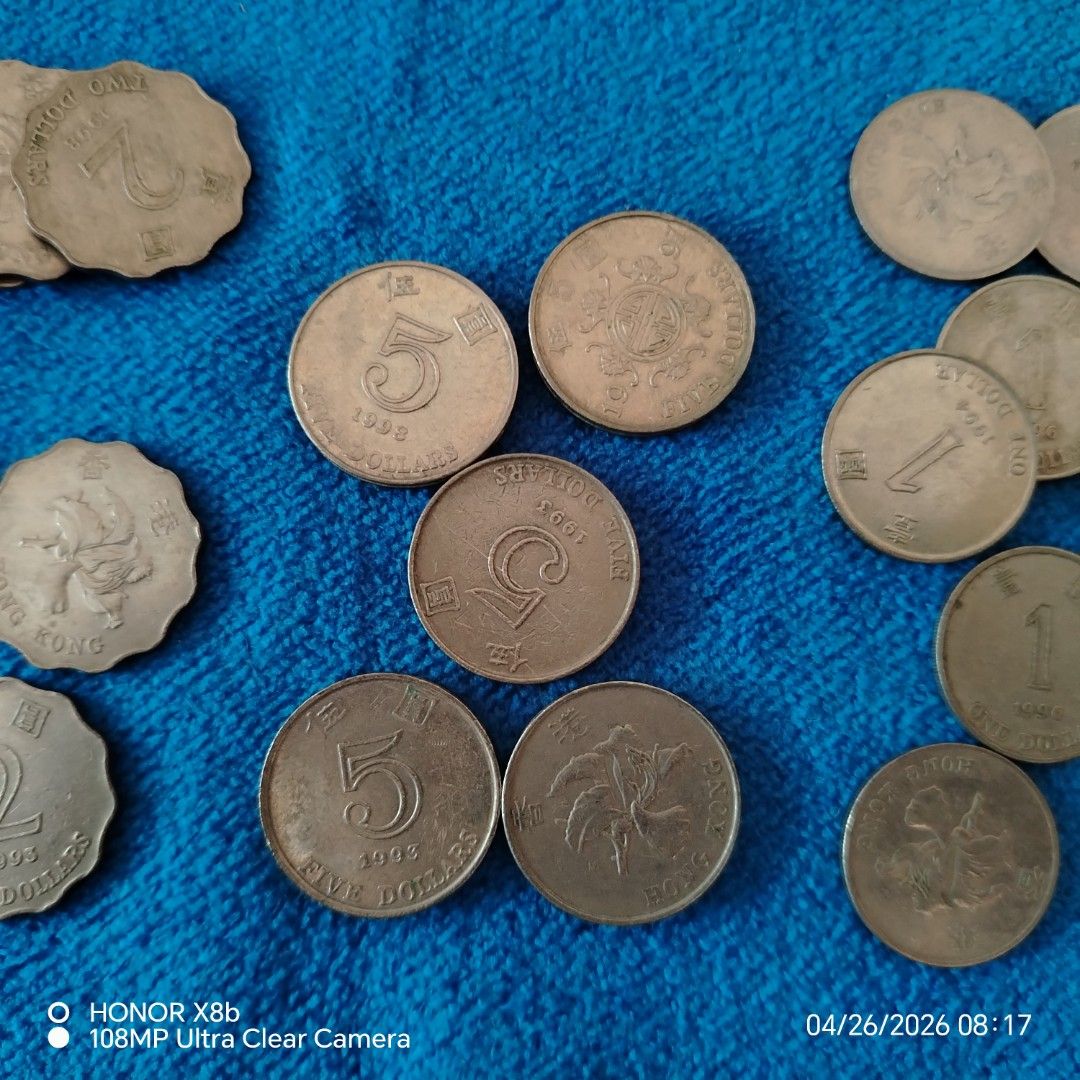 Hong Kong Coins (Category: Currency) located in Manila. Submitted by bren09 (Listing ID 1434389640, Image 3). Description: - Hong Kong coin collection. - Includes: 1 dollars, 5 dollar, 2 dollars. - Coins from various years. - Coins are displayed on a blue cloth. - Exact quantities not specified..