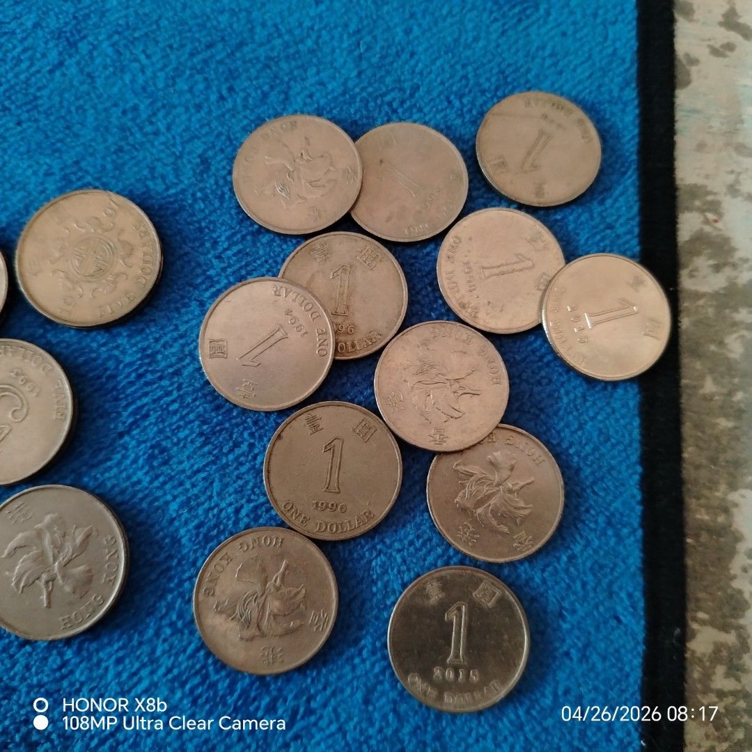 Hong Kong Coins (Category: Currency) located in Manila. Submitted by bren09 (Listing ID 1434389640, Image 2). Description: - Hong Kong coin collection. - Includes: 1 dollars, 5 dollar, 2 dollars. - Coins from various years. - Coins are displayed on a blue cloth. - Exact quantities not specified..