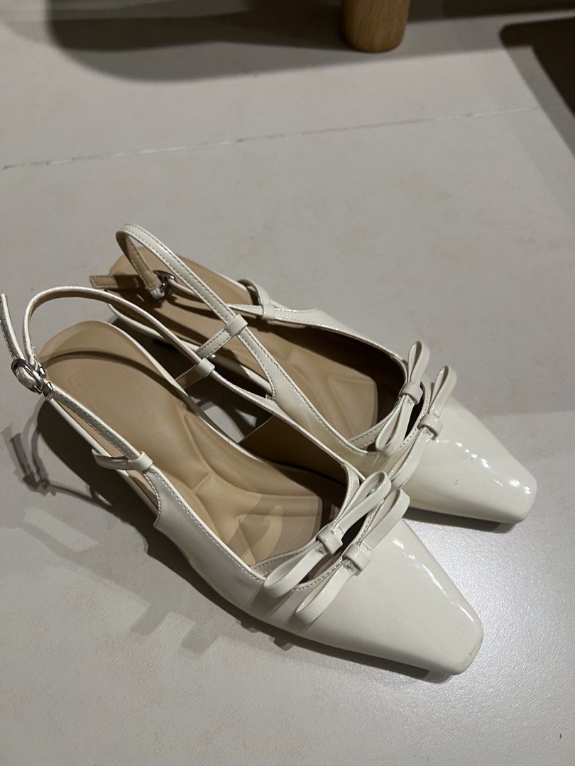 Hue Poppy in Creme (Category: Heels) located in Pasig City. Submitted by decluttermycloset.24 (Listing ID 1434555655, Image 3). Description: - Hue Poppy in Creme - Material: Premium patent leather - Heel height: 1.5 inches - Insole: Ergonomic soft cushion - No longer available on website - Minor flaw (see last pic) but can be fixed with superglue - Super comfy! Slightly negotiable.