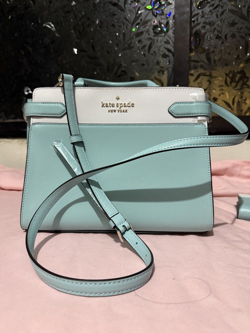 Kate Spade Staci Two Toned Satchel Two way bag (Category: Luxury Bags & Wallets) located in Pasig City. Submitted by help.a.hoarder.out (Listing ID 1434577982, Image 2). Description: - Kate Spade two way bag - Saffiano leather - Dual-tone light poolside blue and white color - Top handle and detachable sling - Main compartment with zipper closure - Interior pocket - Includes original tags - Kate Spade logo visible - Bag dimensions all in inches, L