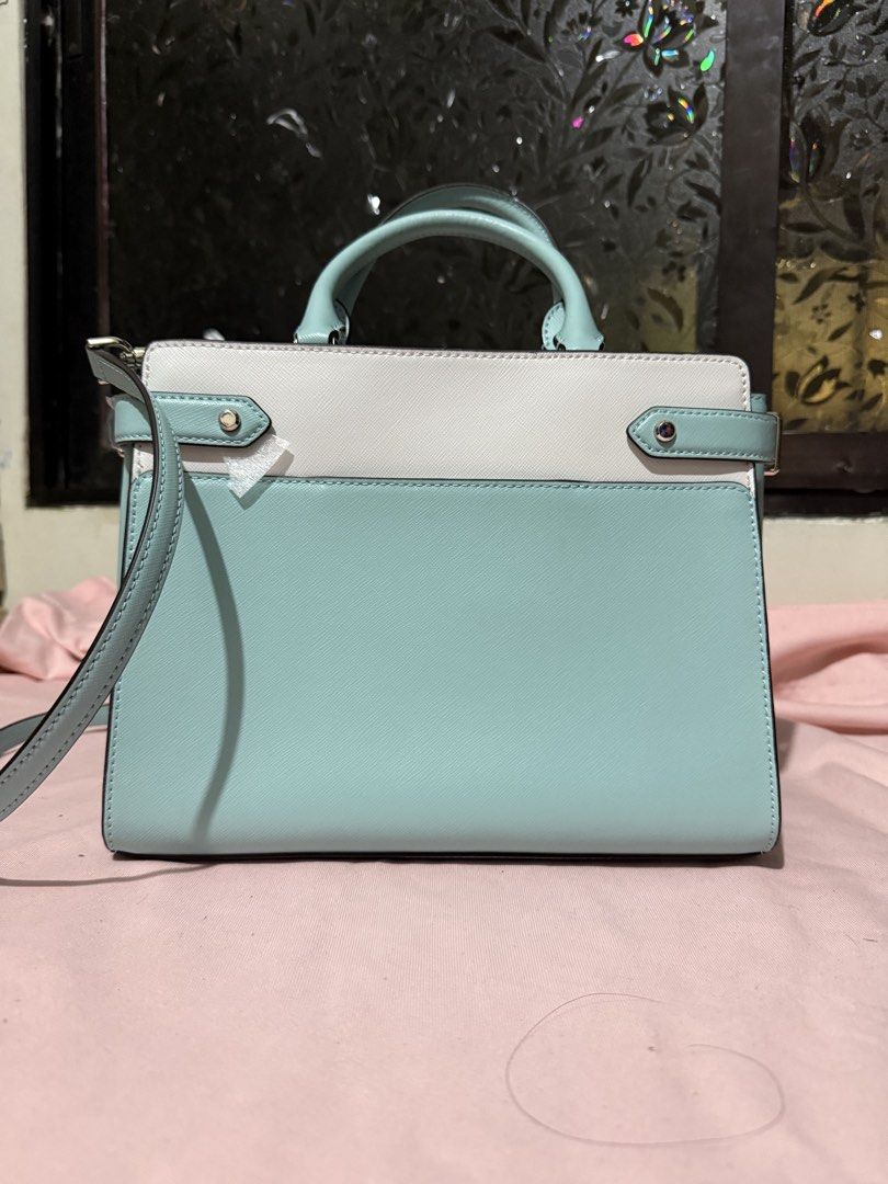 Kate Spade Staci Two Toned Satchel Two way bag (Category: Luxury Bags & Wallets) located in Pasig City. Submitted by help.a.hoarder.out (Listing ID 1434577982, Image 3). Description: - Kate Spade two way bag - Saffiano leather - Dual-tone light poolside blue and white color - Top handle and detachable sling - Main compartment with zipper closure - Interior pocket - Includes original tags - Kate Spade logo visible - Bag dimensions all in inches, L