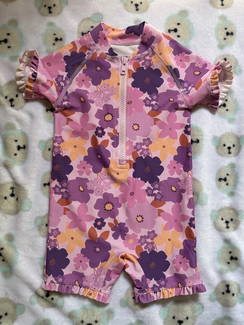 Kids Swimsuit (Category: Babies & Kids Fashion) located in San Juan City. Submitted by prelaabthings (Listing ID 1434436729, Image 1). Description: - Next baby swimsuit - Size: 9-12 months (80cm, 11kg/24lbs) - Vibrant floral print (pink, purple, orange) - Front zipper - Ruffled sleeves and leg openings - UPF 40+ sun protection - Made with recycled polyester and elastane.