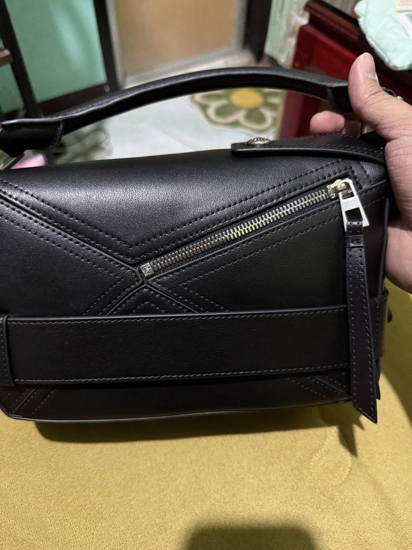 Loewe Puzzle Bag Small (Category: Luxury Bags & Wallets) located in Cabuyao City. Submitted by girliecloset202434 (Listing ID 1434388547, Image 2). Description: Inclusion: No dust bag Condition: good as new (no declared flaws) Color: Black Material: Soft calfskin leather Hardware: Silver Zipper underzip: Loewe With adjustable strap No box no paper bag Last price upon request No return no exchange! Please read before buying .