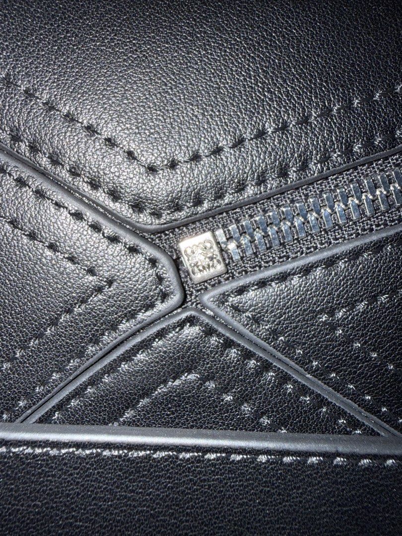 Loewe Puzzle Bag Small (Category: Luxury Bags & Wallets) located in Cabuyao City. Submitted by girliecloset202434 (Listing ID 1434388547, Image 3). Description: Inclusion: No dust bag Condition: good as new (no declared flaws) Color: Black Material: Soft calfskin leather Hardware: Silver Zipper underzip: Loewe With adjustable strap No box no paper bag Last price upon request No return no exchange! Please read before buying .
