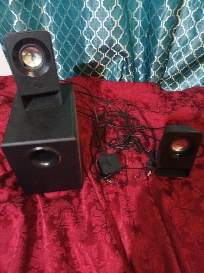 Logitech Speaker System (Category: Soundbars, Speakers & Amplifiers) located in Makati City. Submitted by epic_prelovedmakati (Listing ID 1434426289, Image 1). Description: - Logitech speaker system - Includes subwoofer and two satellite speakers - Features a control pod for volume and power - Rear-mounted volume control on subwoofer - Comes with multiple connectivity cables - Sleek black design.