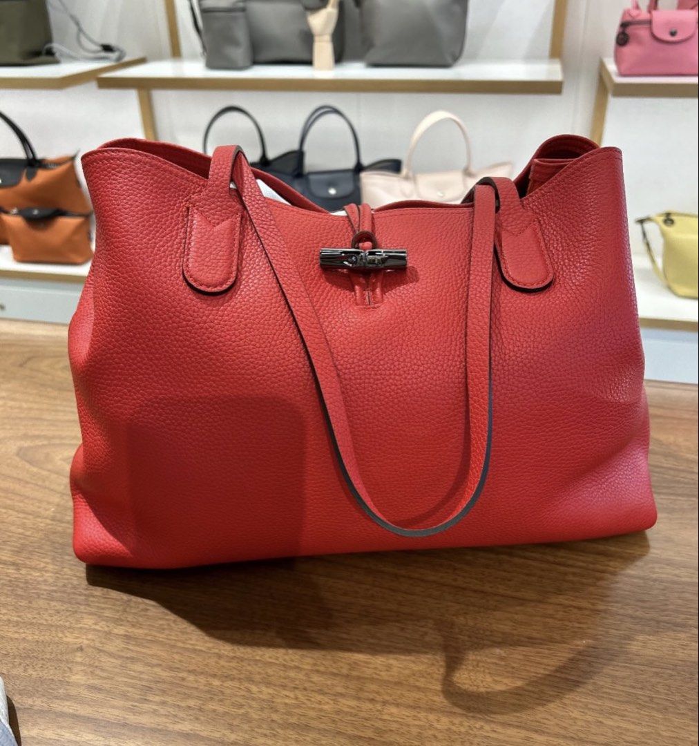 Longchamp Roseau Leather Tote Bag - Red (Category: Luxury Bags & Wallets) located in San Fernando. Submitted by currency_sy (Listing ID 1414810250, Image 2). Description: - Authentic Longchamp Roseau tote bag - Classic red color - Bamboo-style closure - Made of textured leather - Two top handles - Spacious interior.