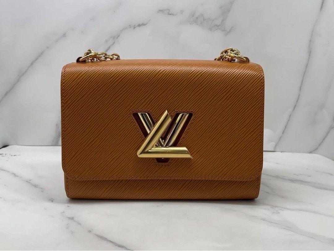 Louis Vuitton Twist PM Epi Leather Bag (Category: Luxury Bags & Wallets) located in Quezon City. Submitted by curatedbyamethyst (Listing ID 1434599843, Image 1). Description: - Authentic Louis Vuitton Twist PM. - Crafted from tan Epi leather. - Signature LV twist lock. - Gold-toned hardware. - Chain strap with leather shoulder pad. - Interior: Two compartments and a slip pocket..