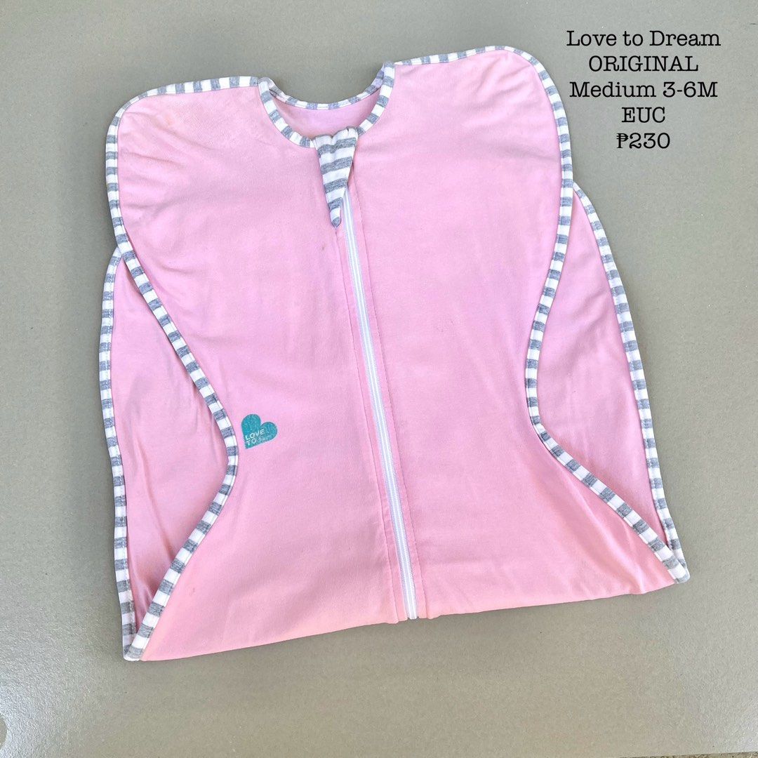 Love to Dream Original Swaddle Medium 3-6M (Category: Babies & Kids Fashion) located in Davao. Submitted by snuggleswaddle (Listing ID 1434527028, Image 1). Description: - Love to Dream Original swaddle - Color: Pink - Size: Medium (3-6 months) - Features a full-length zipper for easy changes - Heart logo and striped trim - Price: ₱230.