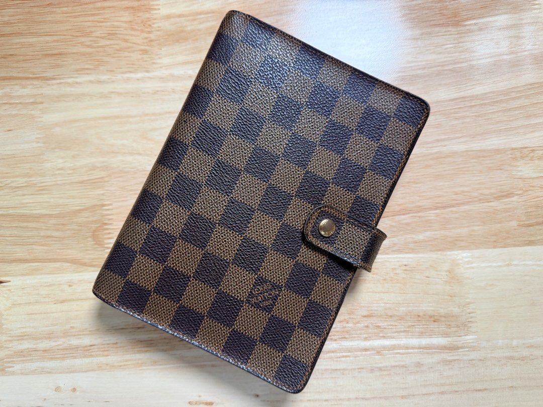 LV Agenda MM in Damier Ebene (Category: Luxury Bags & Wallets) located in Antipolo. Submitted by shopfromdawn (Listing ID 1434408526, Image 1). Description: Selling my preloved LV Agenda MM in Damier Ebene (genuine) Some tarnishings and signs of use evident, otherwise in very good used condition 🙂 Selling for p19,000 negotiable only for sure buyer Can include some blank filofax/moterm inserts *Send me a message if interested, can provide a detai