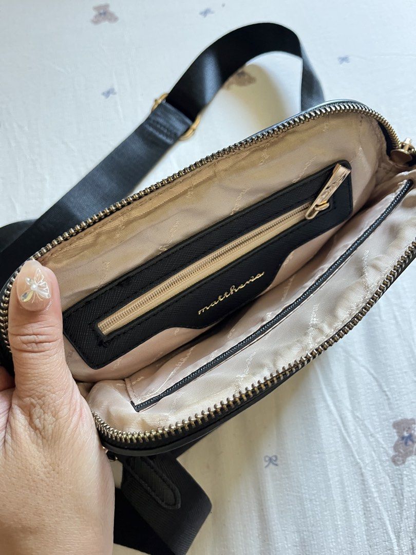 Matthew Black Crossbody Bag (Category: Cross-body Bags) located in Manila. Submitted by heraaa21 (Listing ID 1434410223, Image 3). Description: - Matthew black crossbody bag - Adjustable black strap with gold hardware - Secure zip closure - Includes a small interior pocket - Light beige interior lining - Features the Matthew logo - still in very good condition.