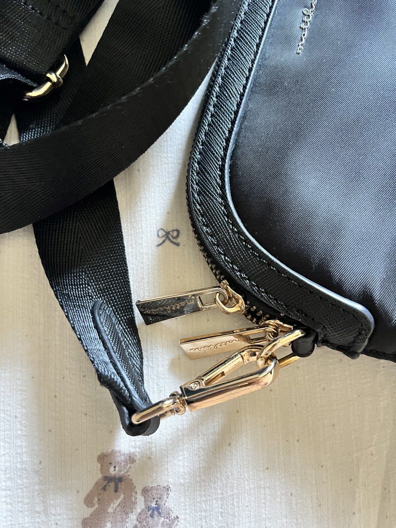 Matthew Black Crossbody Bag (Category: Cross-body Bags) located in Manila. Submitted by heraaa21 (Listing ID 1434410223, Image 2). Description: - Matthew black crossbody bag - Adjustable black strap with gold hardware - Secure zip closure - Includes a small interior pocket - Light beige interior lining - Features the Matthew logo - still in very good condition.