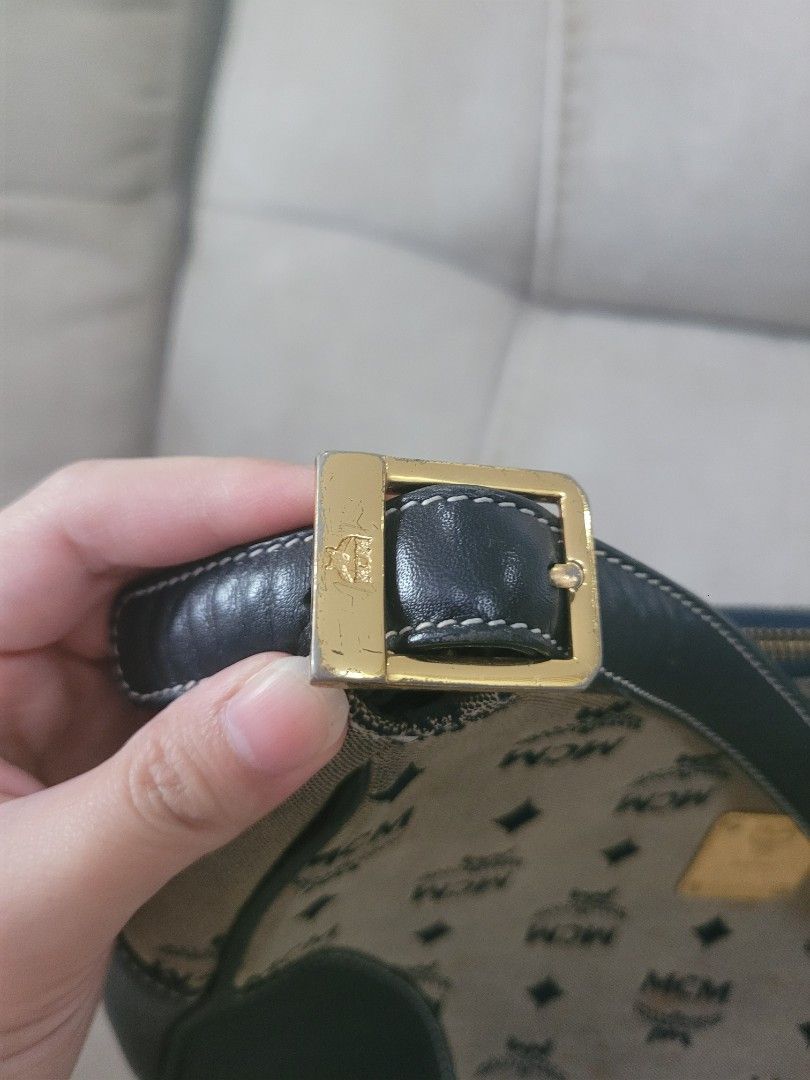 MCM Shoulder Bag (Category: Luxury Bags & Wallets) located in Antipolo. Submitted by dlolin (Listing ID 1434390321, Image 3). Description: - Authentic MCM shoulder bag - Iconic MCM logo pattern - Black leather trim and strap - MCM logo lining - Gold-tone buckle - Includes MCM logo plate with serial number - Shows visible wear and tear.