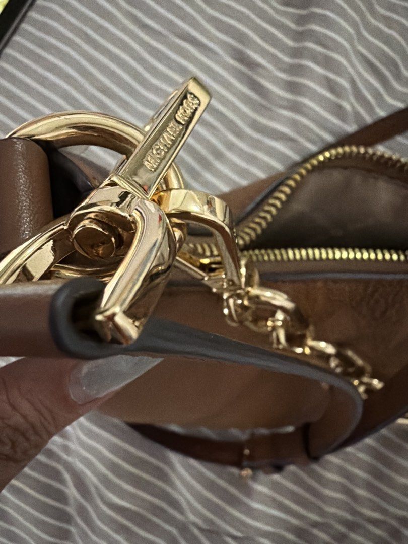 Michael Kors bag (Category: Luxury Bags & Wallets) located in Pateros City. Submitted by nightingayle29 (Listing ID 1434460593, Image 3). Description: - Michael Kors shoulder bag - Brown leather exterior - Gold chain detail - Branded fabric lining - Detachable strap - Zipper closure - Gold-toned hardware - Includes care card and tag - please see when worn photo also.