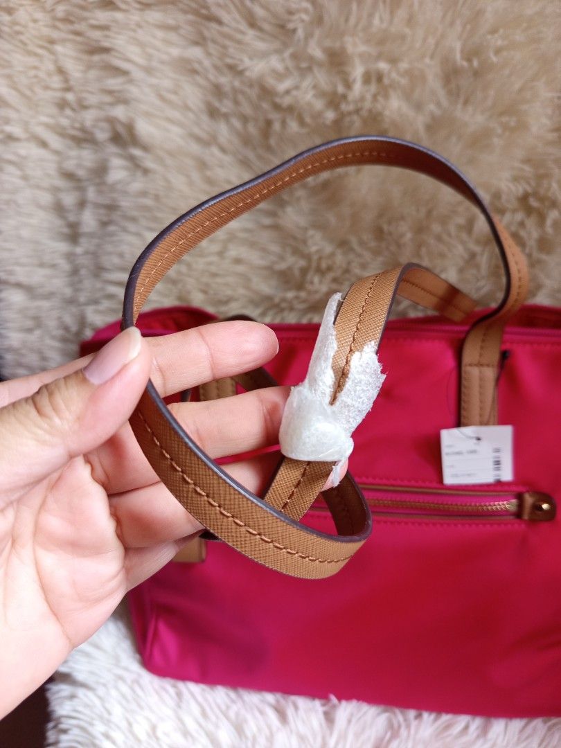 Michael Kors Pink Tote Bag (Category: Luxury Bags & Wallets) located in Iloilo. Submitted by cezminishop (Listing ID 1434414822, Image 2). Description: - Authentic Michael Kors tote bag - Vibrant pink color - Front zip pocket - Gold-tone hardware - Dual top handles with brown accents - Includes original tags and care card - Interior: zip pocket and slip pocket - Protective metal feet at the bottom -Personally bought in Taiwan -Original price NT$6